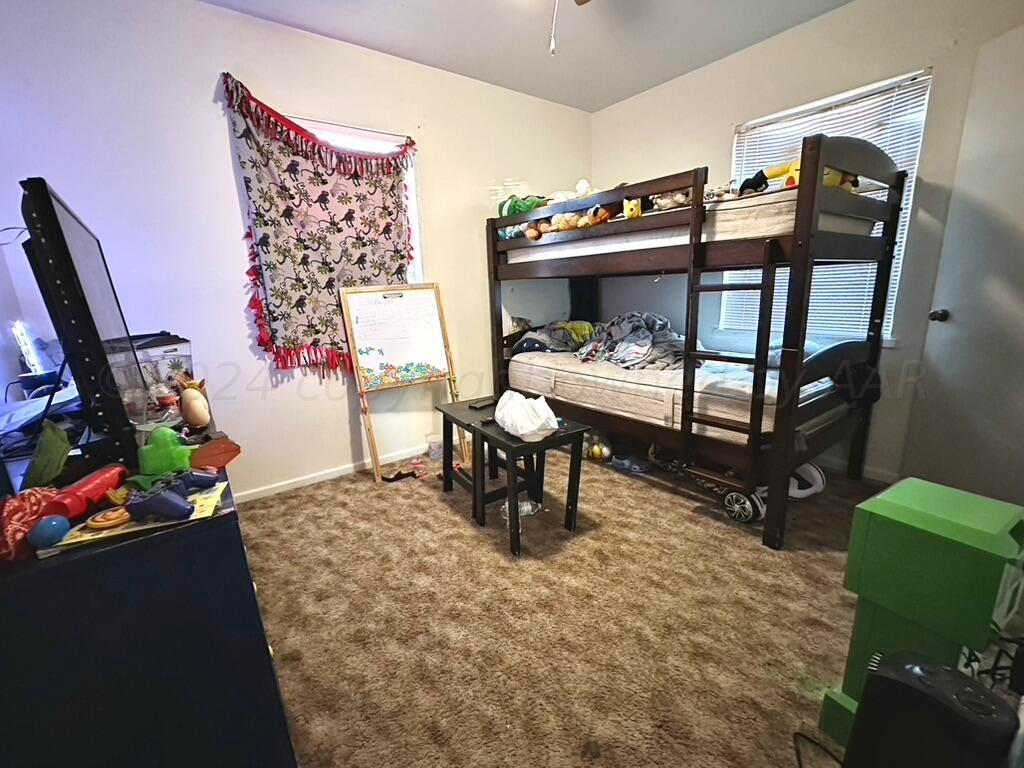 4611 South Ong Street Amarillo, TX 79110 - Photo 8 of 11 a bedroom with furniture and a bed