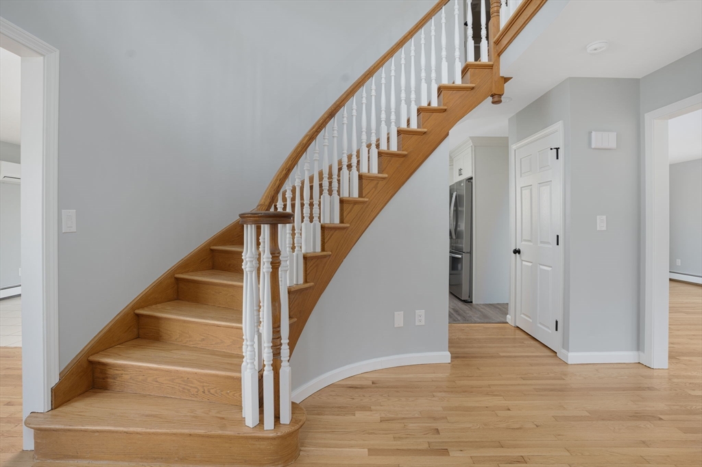 295 Frenchtown Road East Greenwich, RI 02818 - Photo 3 of 26 a view of staircase with wooden floor and white walls