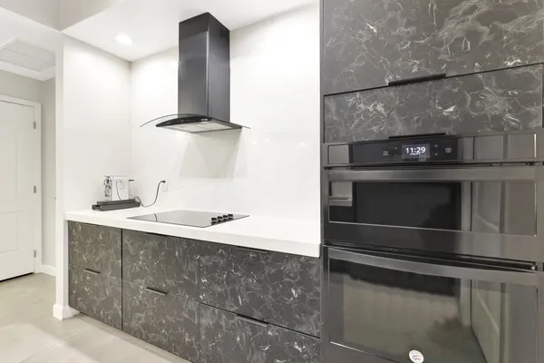 a sink with a stove and mirror