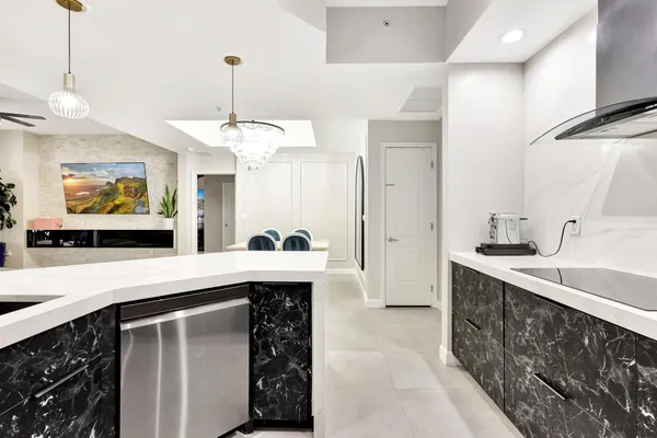 a kitchen with stainless steel appliances granite countertop a sink and a stove