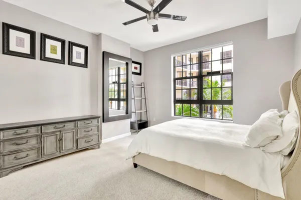 a spacious bedroom with a large bed and a window