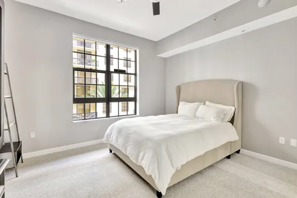 a large bed sitting in a bedroom next to a window