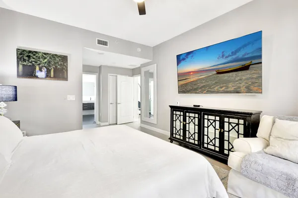 a bedroom with a large bed and a couch