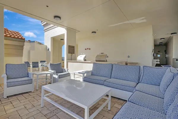 a view of a swimming pool and an outdoor seating