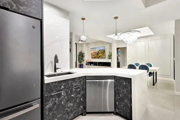 a kitchen with a sink cabinets and window