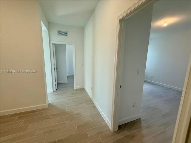 a view of a hallway with a room