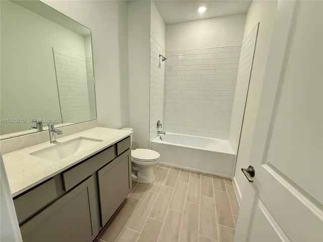 a bathroom with a double vanity sink toilet and shower