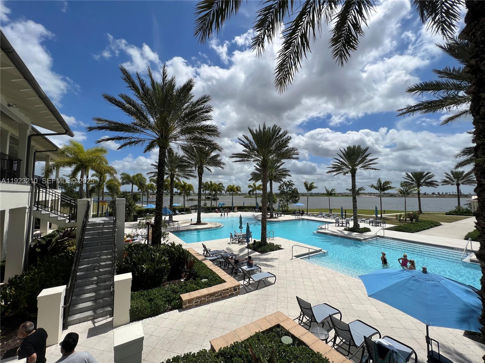 19600 Whispering Creek Road, Unit 19600 West Palm Beach, FL 33470 - Photo 16 of 26 a view of a patio with swimming pool