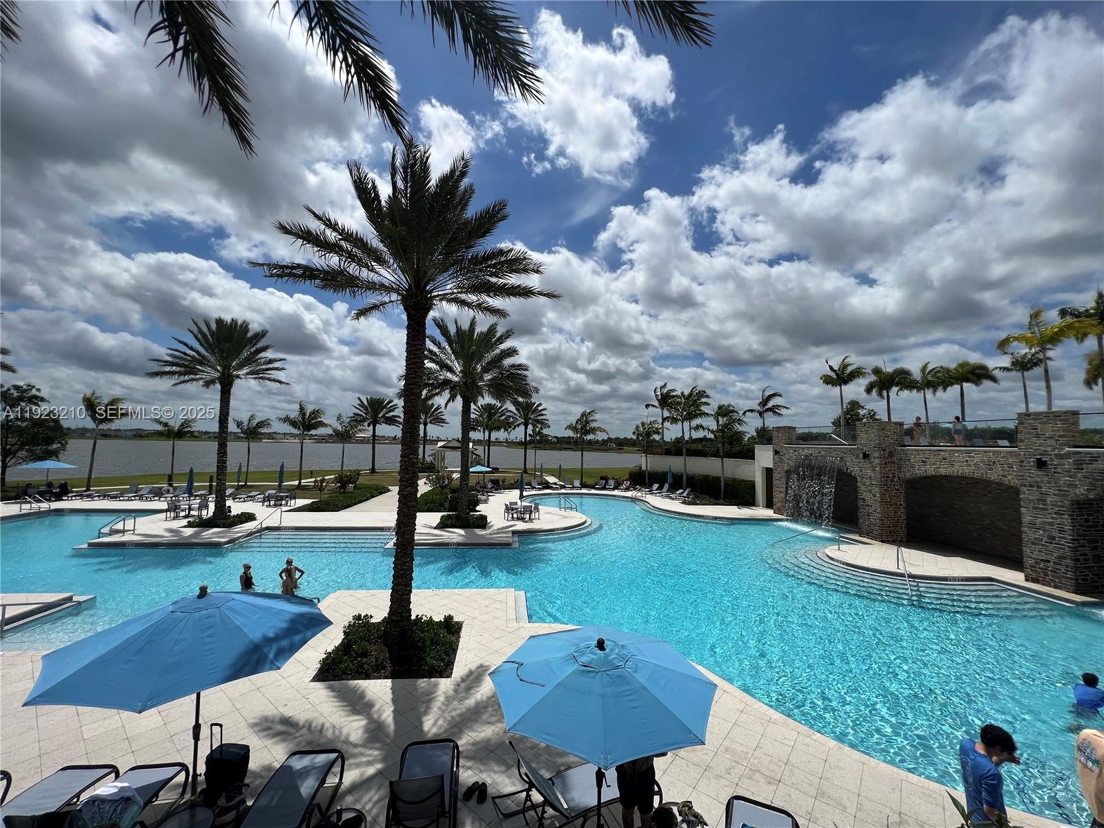 19600 Whispering Creek Road, Unit 19600 West Palm Beach, FL 33470 - Photo 17 of 26 a view of a patio with swimming pool
