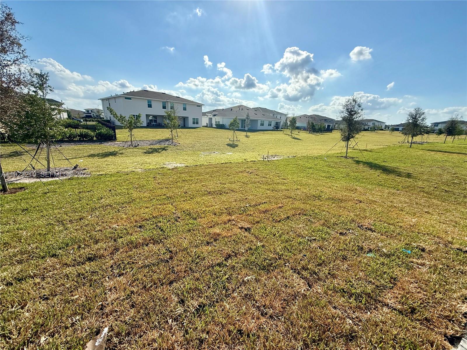 19600 Whispering Creek Road, Unit 19600 West Palm Beach, FL 33470 - Photo 2 of 26 a view of a swimming pool with an outdoor space and seating area