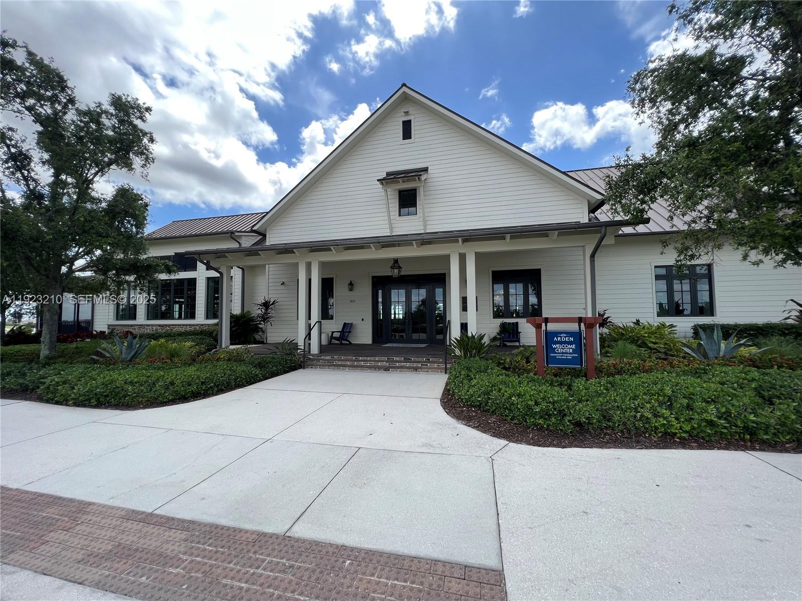 19600 Whispering Creek Road, Unit 19600 West Palm Beach, FL 33470 - Photo 25 of 26 a front view of a house with garden