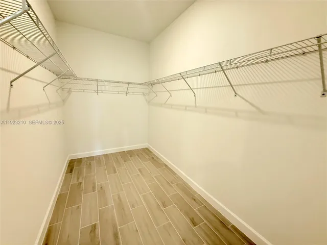 a view of a room with wooden floor