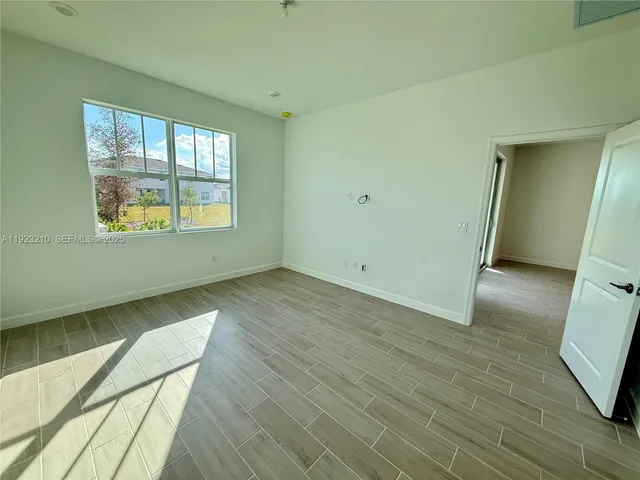 a view of wooden floor and windows in a room
