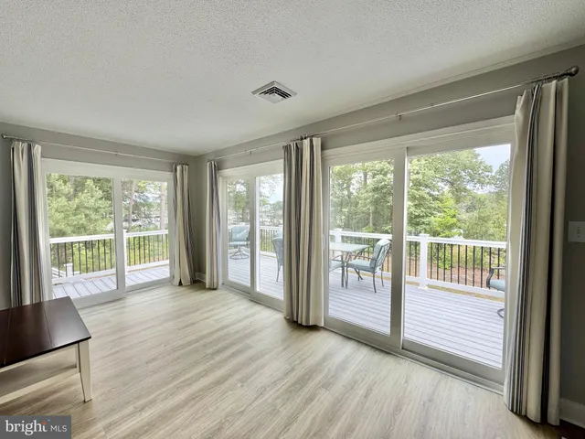 a view of a chairs and table on the balcony