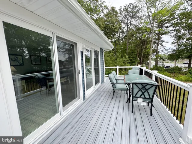 a view of a room with wooden floor and outdoor space
