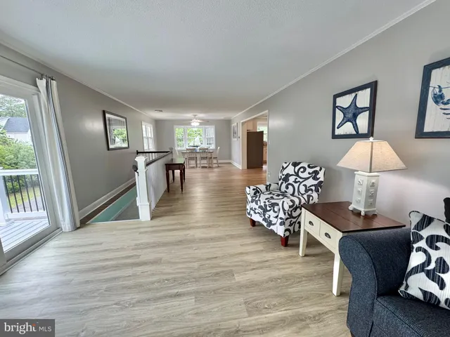a view of a kitchen with a sink a microwave and cabinets