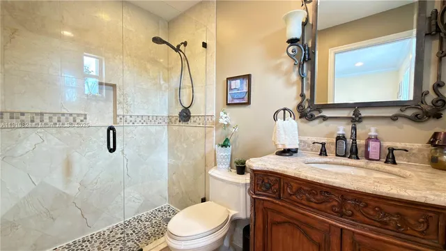 a bathroom with a toilet a sink and a mirror