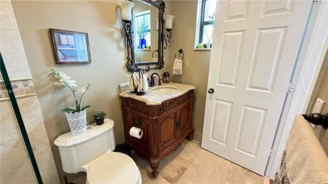 a bathroom with a sink a mirror and shower