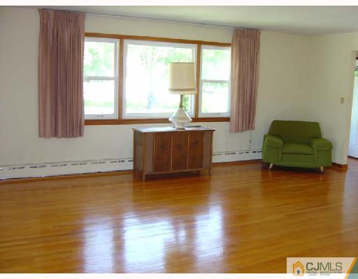 888 Hermann Road North Brunswick, NJ 08902 - Photo 6 of 10 a living room with hard wood floors and a window