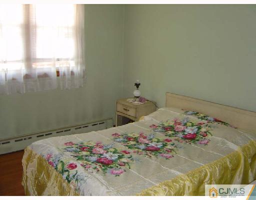 888 Hermann Road North Brunswick, NJ 08902 - Photo 8 of 10 a bedroom with a bed and a window