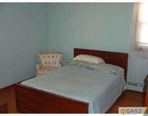888 Hermann Road North Brunswick, NJ 08902 - Photo 9 of 10 a bedroom with a bed and window