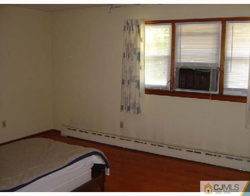 888 Hermann Road North Brunswick, NJ 08902 - Photo 10 of 10 a room with a bed and a window