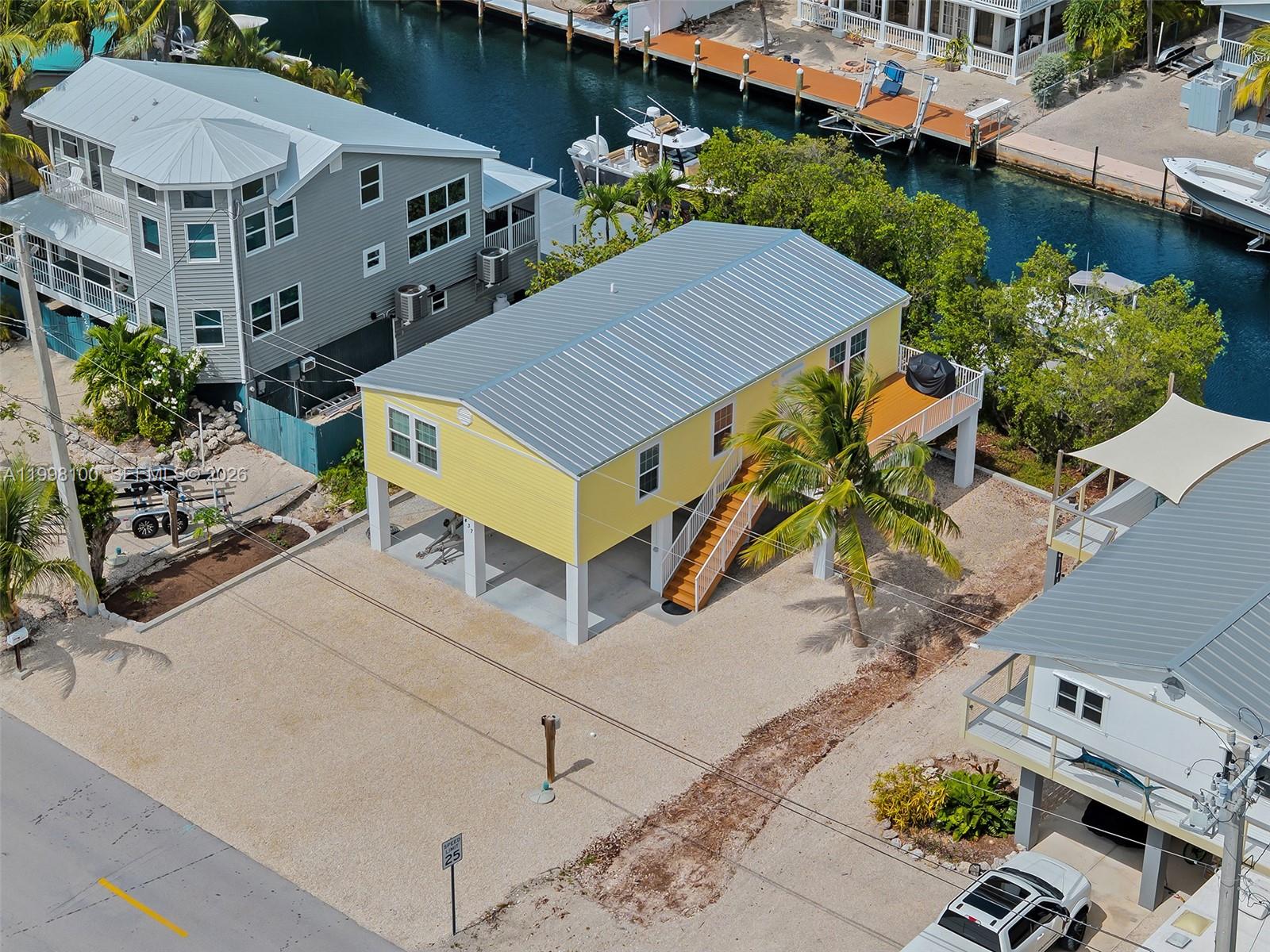 437 Pirates Road Summerland Key, FL 33042 - Photo 2 of 39 an aerial view of a house with yard and patio