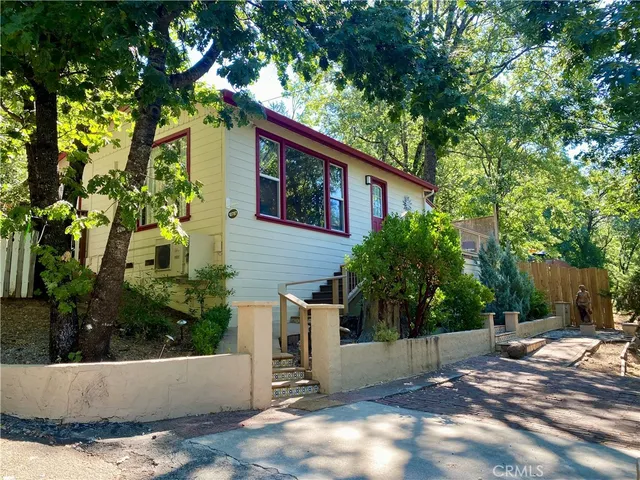 a view of a small yard in front of a white house