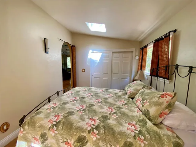a bedroom with a bed and a mirror