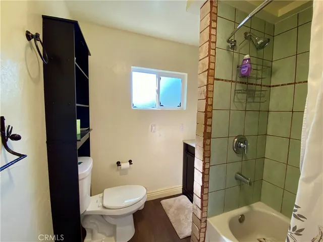 a bathroom with a toilet and shower