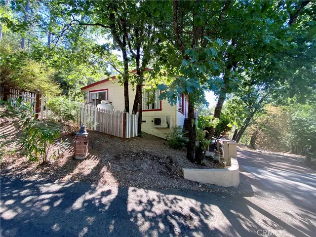 a view of a house with backyard sitting area and garden