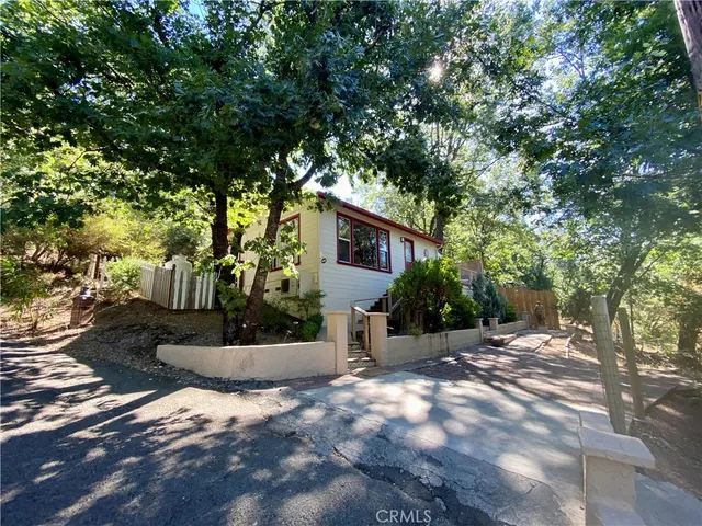 a view of a house with a tree in the background