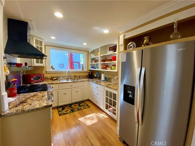 a kitchen with a refrigerator a stove top oven a sink and dishwasher