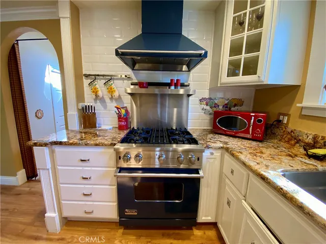 a kitchen with stainless steel appliances granite countertop a stove and a microwave