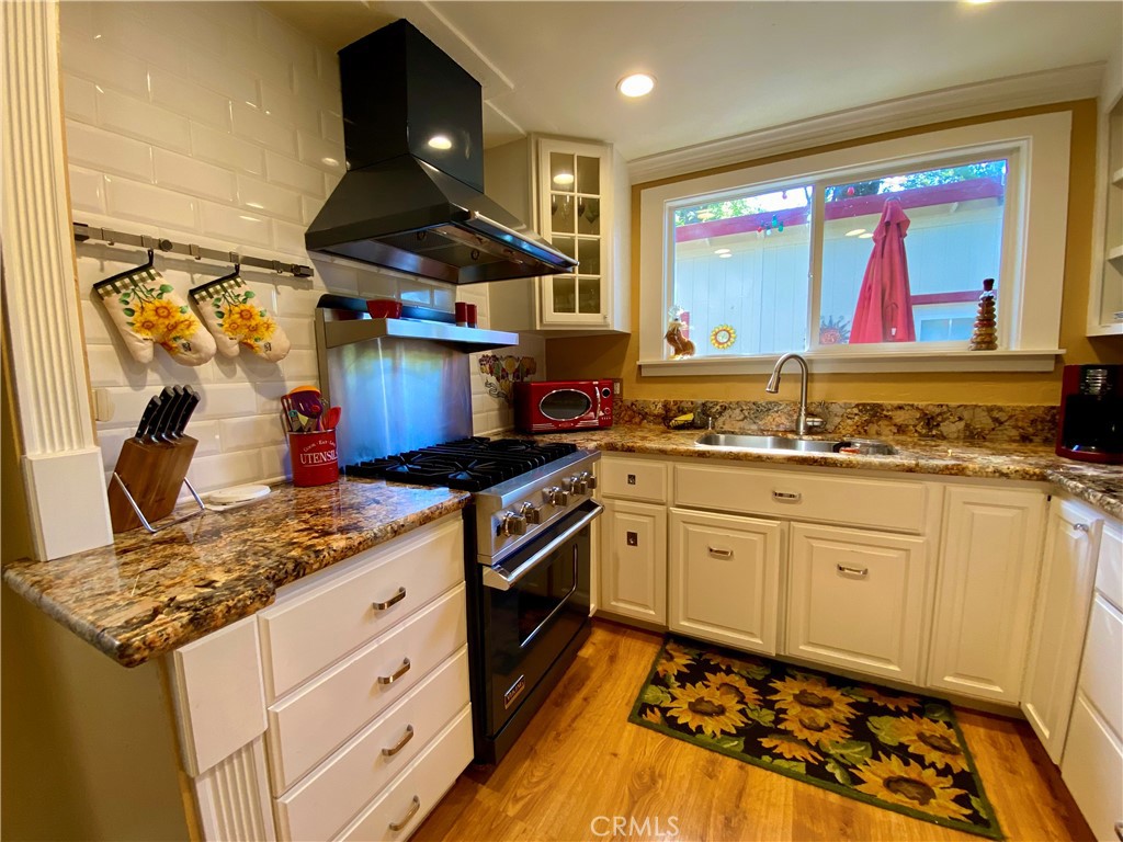 10787 Foothill Road Middletown, CA 95461 - Photo 10 of 23 a kitchen with stainless steel appliances granite countertop a stove a sink and a microwave