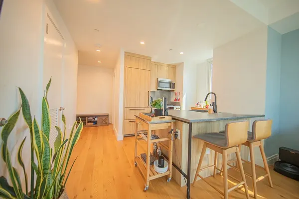 a view of a dining room with furniture and wooden floor
