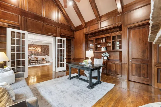 a living room with furniture a fireplace and wooden floor