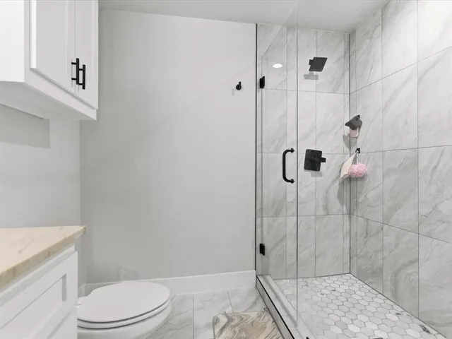 a bathroom with a toilet and shower