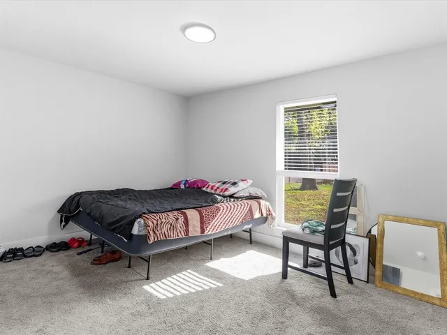a bedroom with a bed and a desk