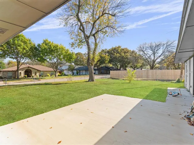a view of a park with large trees