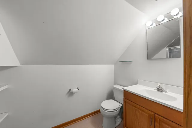 a bathroom with a sink a toilet and mirror