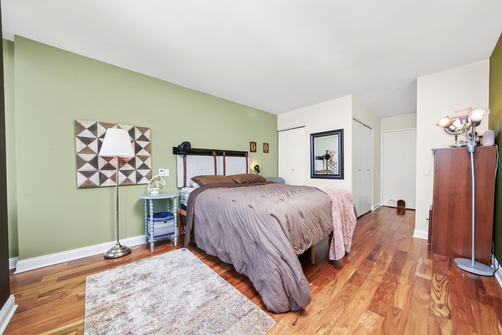 5320 North Sheridan Road, Unit 2304 Chicago, IL 60640 - Photo 11 of 28 a bedroom with a bed and a table in it