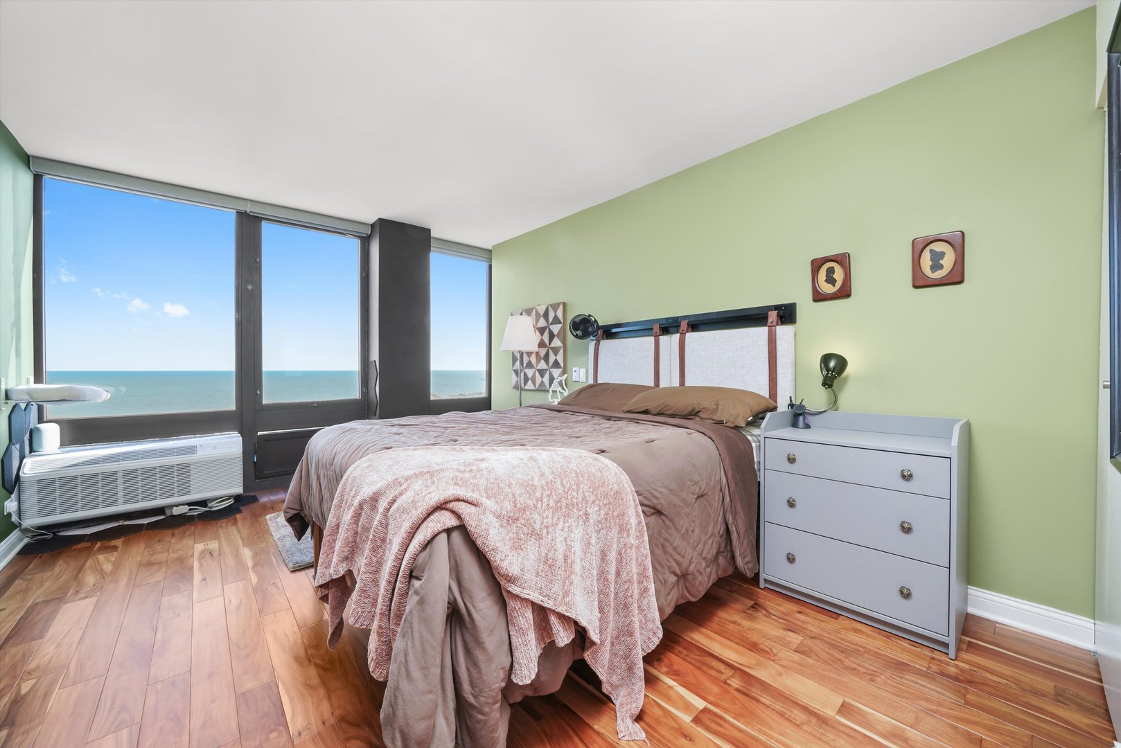 5320 North Sheridan Road, Unit 2304 Chicago, IL 60640 - Photo 10 of 28 a bedroom with a bed and a large window