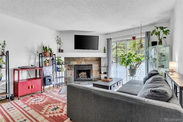 a living room with furniture and a fireplace