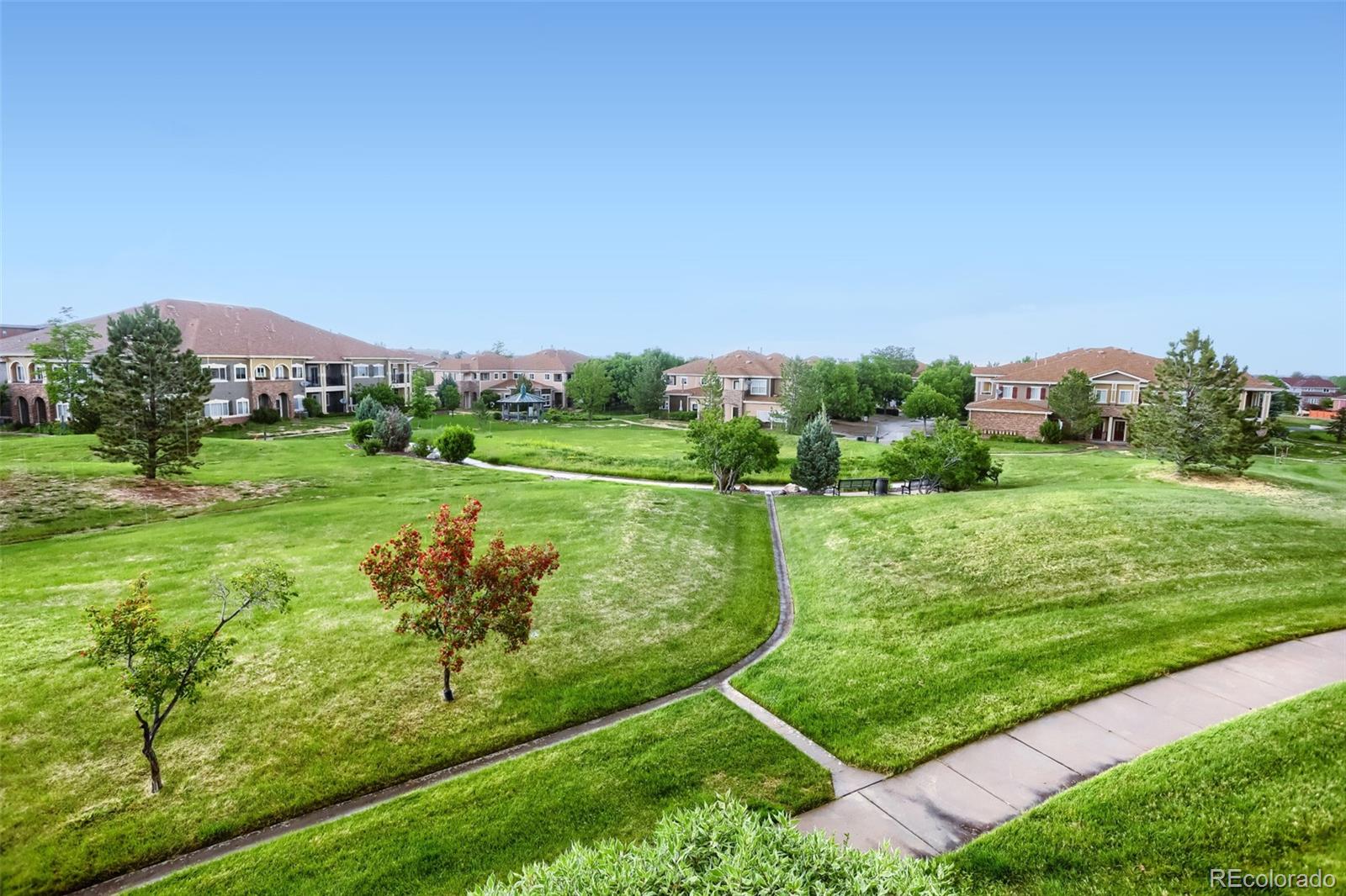 6232 Kilmer Loop, Unit 203 Golden, CO 80403 - Photo 32 of 33 a view of a big yard with potted plants and a large tree