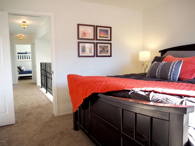 a bedroom with a bed and a couch