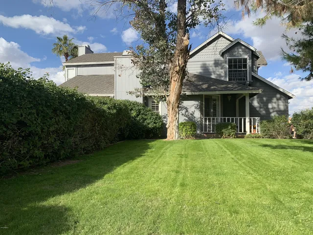 a view of a patio with table and chairs with plants and wooden fence