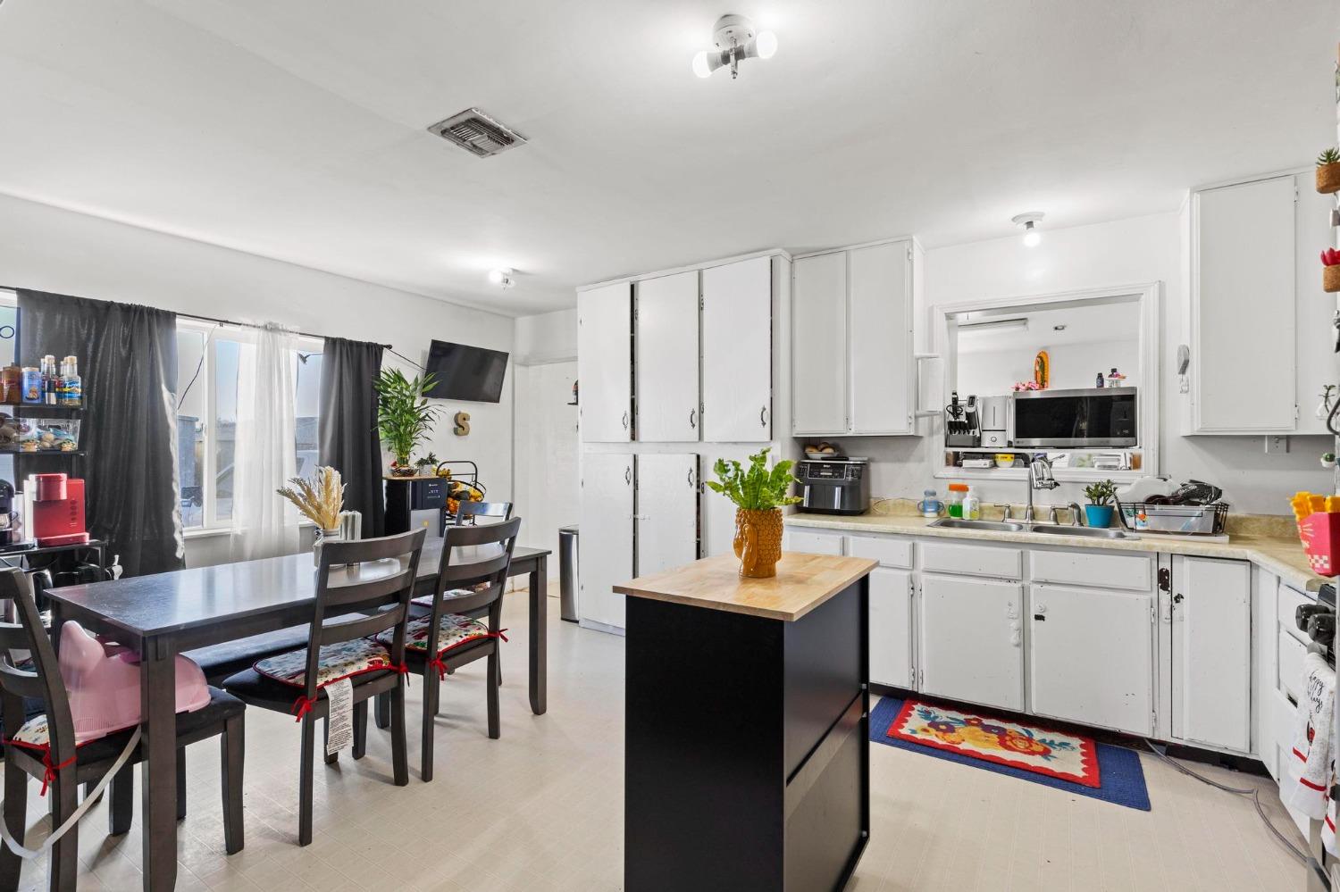 6944 Greenbay Road Arbuckle, CA 95912 - Photo 12 of 18 a kitchen with white cabinets and stainless steel appliances