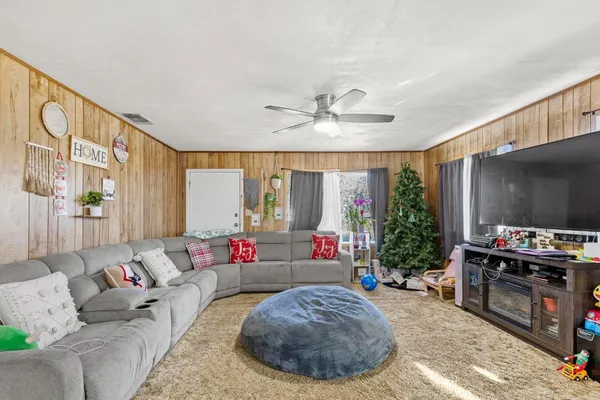 a living room with furniture and a flat screen tv