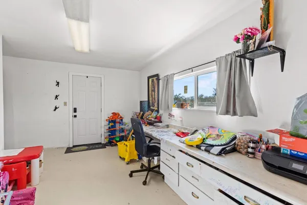 a kitchen with stainless steel appliances a stove a refrigerator a sink dishwasher and white cabinets with wooden floor